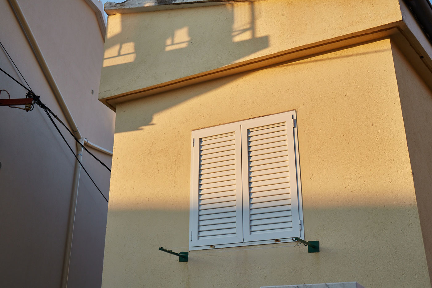 yellow walls and white shutters